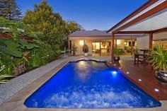 Swimming pool lit with green LED lighting at night
